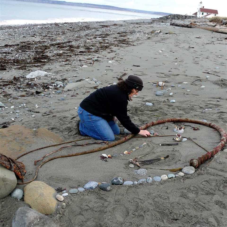 Fran making art on the beach